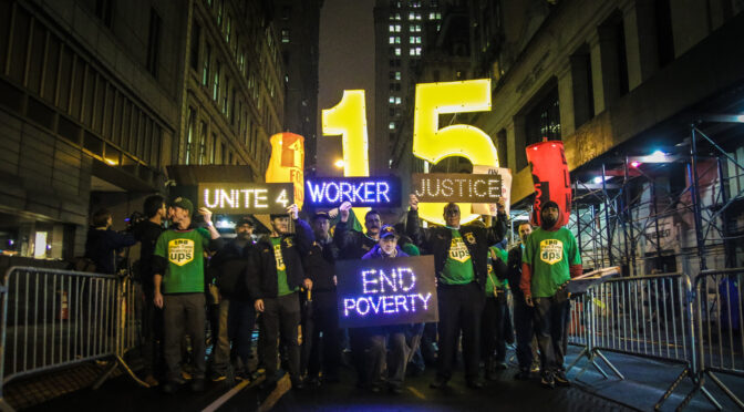 workers holding signs that say united, justice, and end poverty